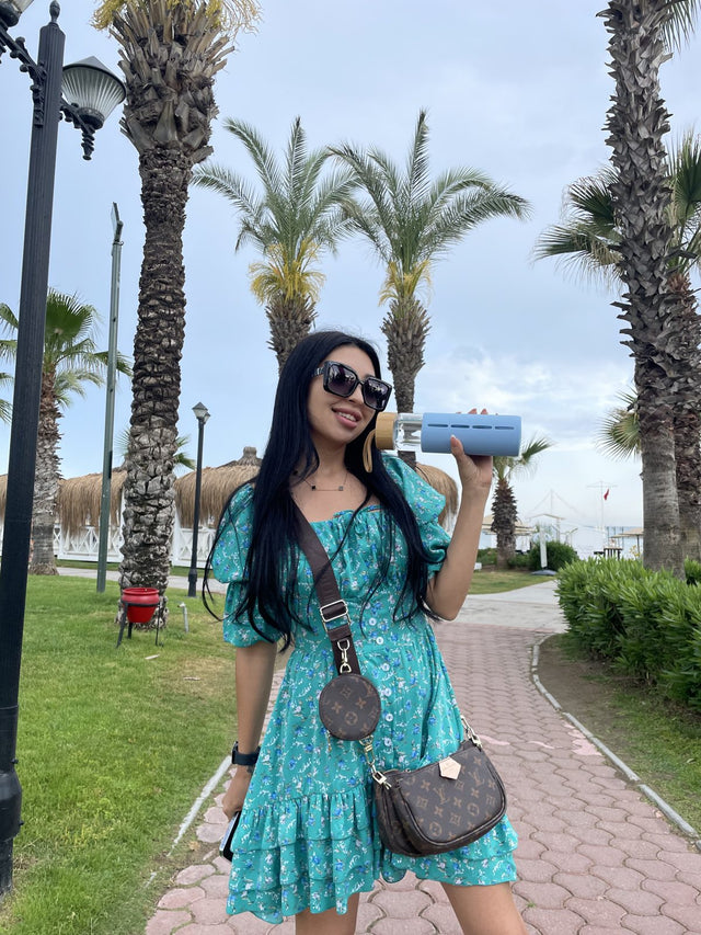 Blue bottle beside palm trees